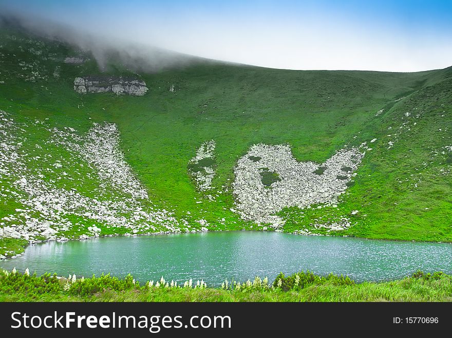 Blue mountain lake in the clouds