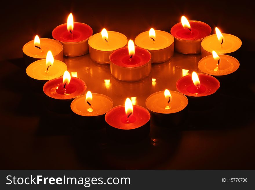 Fourteen lighting little candles in form of heart