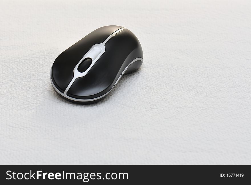 Simple still-life of a wireless mouse on a white backdrop