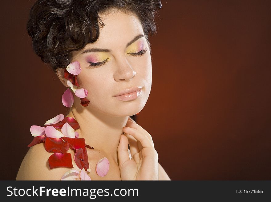Portrait of a girl with beautiful make-up and rose petals. Portrait of a girl with beautiful make-up and rose petals