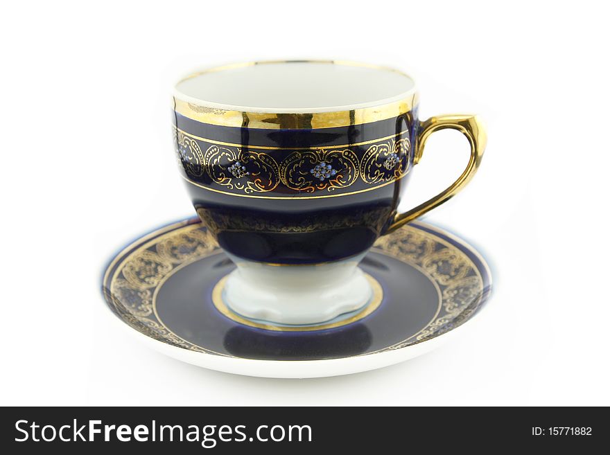 Old cup with golden ornament isolated