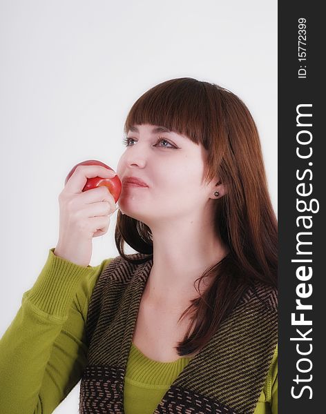 Girl is biting a juicy apple. Girl is biting a juicy apple