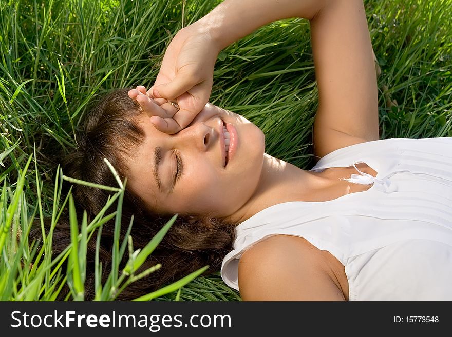 Young girl awaking on the grass meadow. Young girl awaking on the grass meadow