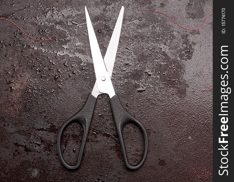 Scissors on rusty metal background. Scissors on rusty metal background