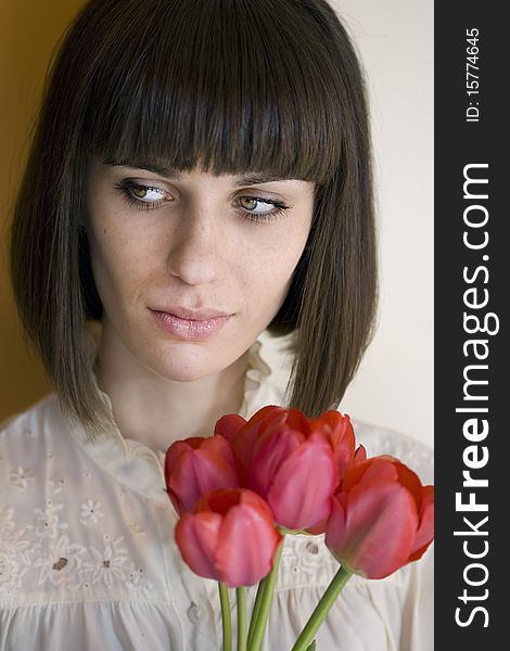 Young beautiful woman holding bouquet of tulips. Young beautiful woman holding bouquet of tulips