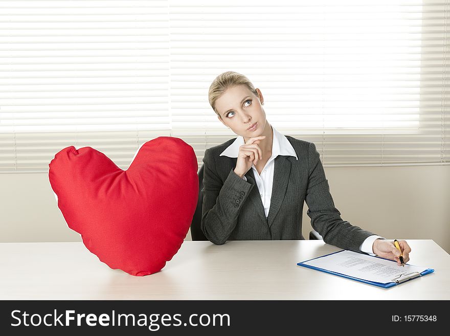 Young businesswoman dreaming of her Valentine date. Young businesswoman dreaming of her Valentine date