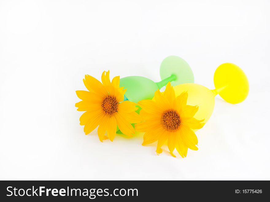 Yellow sunflowers in a cup with a summer theme. Yellow sunflowers in a cup with a summer theme.