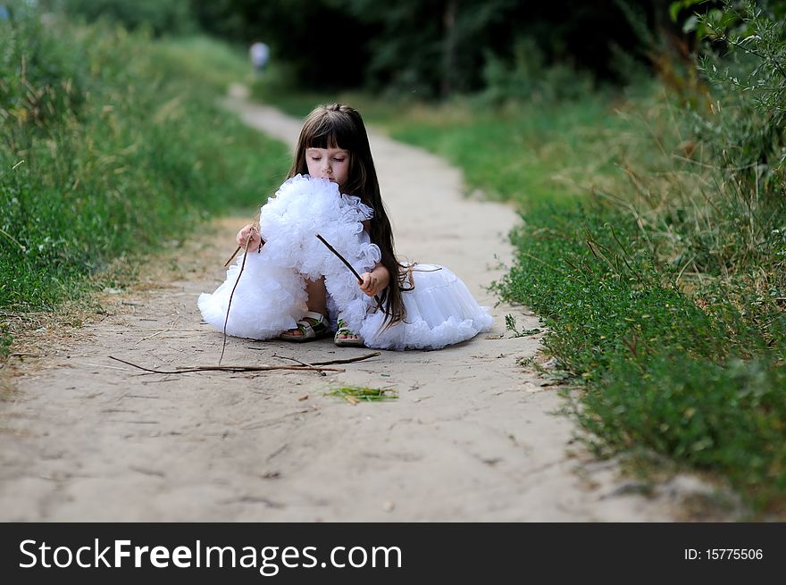 Adorable toddler girl in white tutu skirt