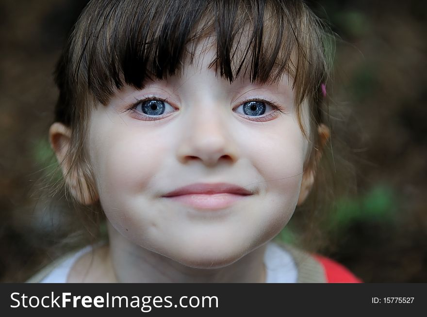 Nice toddler girl with blue eyes looking into the camera
