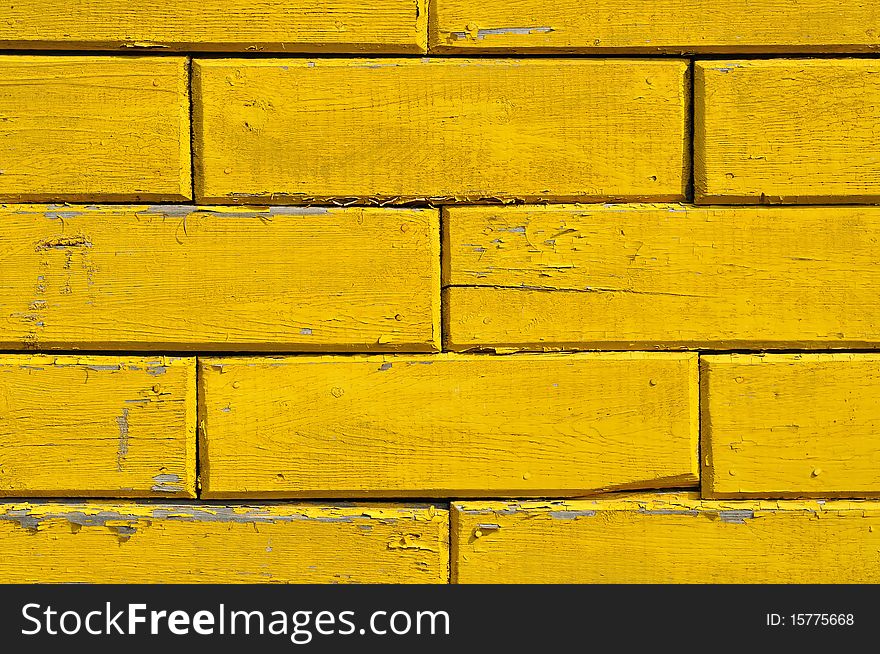 The yellow wooden wall of old house. The yellow wooden wall of old house