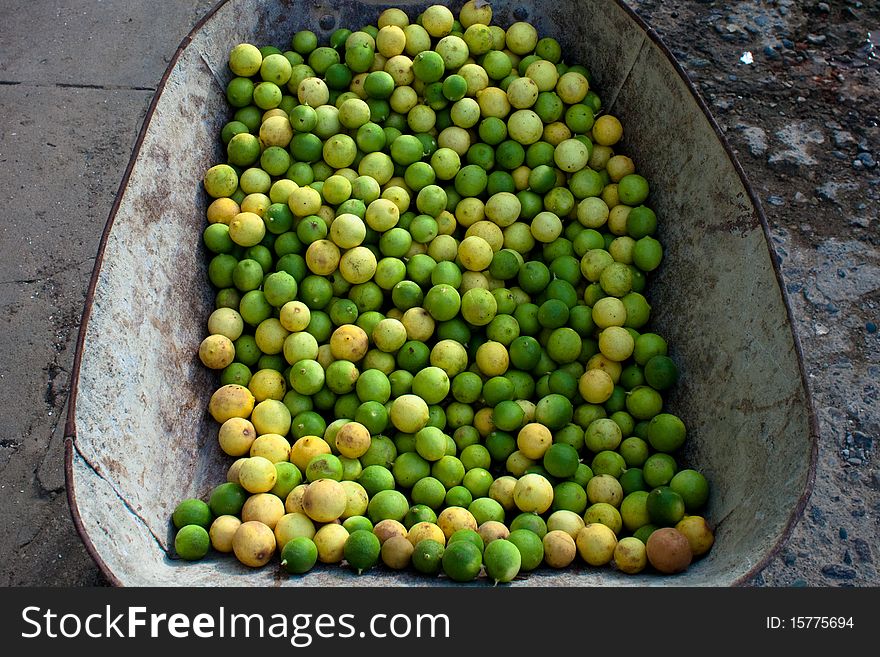 Basket green tropical fresh lemons. Basket green tropical fresh lemons