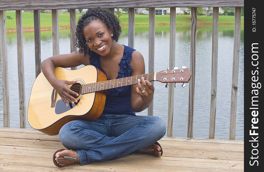 Pretty african-american woman with acoustic guitar. Pretty african-american woman with acoustic guitar