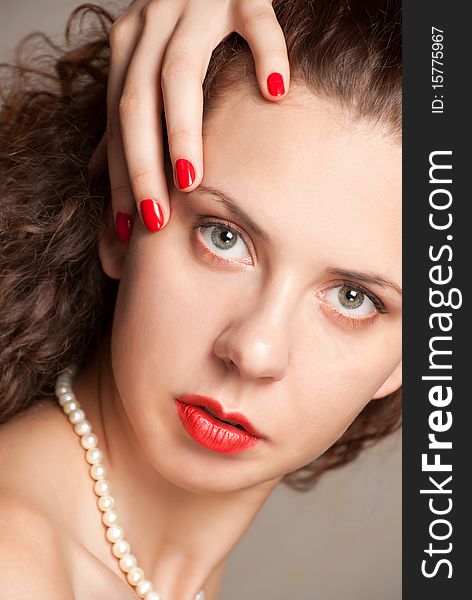 Close-up portrait of caucasian young woman with golden glamour make-up and red bright manicure. Close-up portrait of caucasian young woman with golden glamour make-up and red bright manicure