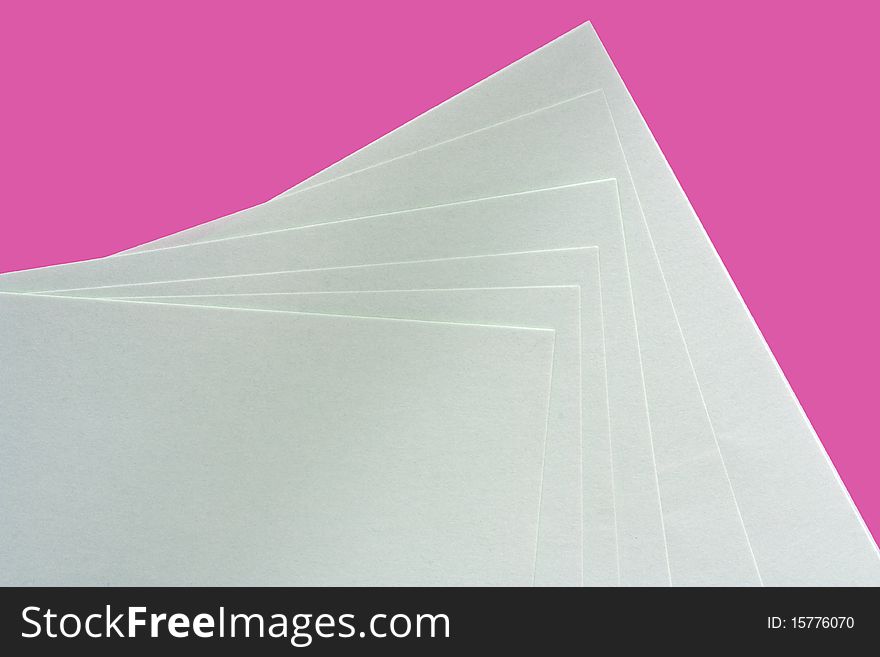 Pink and white paper spread out to form a pattern. Pink and white paper spread out to form a pattern