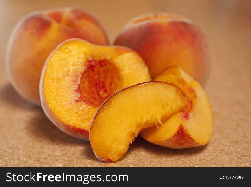 Luscious, ripe peaches. Two whole, one cut. Shallow depth of field. Luscious, ripe peaches. Two whole, one cut. Shallow depth of field.