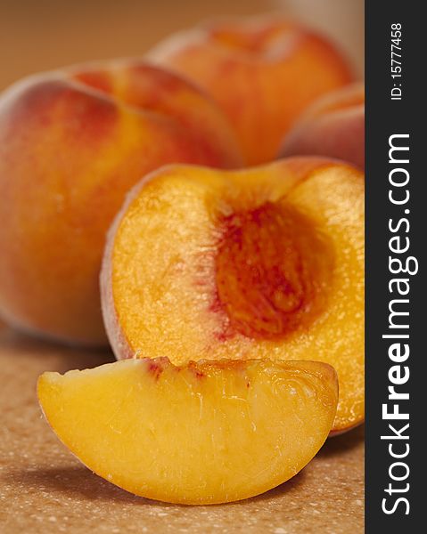 Ripe, delicious peaches. Three whole, one cut. Shallow depth of field. Ripe, delicious peaches. Three whole, one cut. Shallow depth of field.