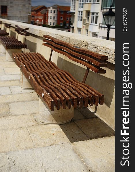 Modern timber wavy seating on a footpath