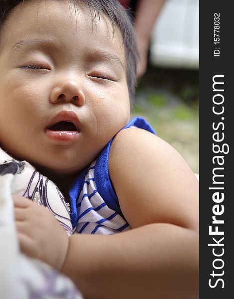 Happy baby sleeping in the arms of his mother. Happy baby sleeping in the arms of his mother