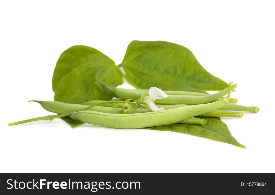 A handful of beans on the green leaf. Isolated on white background. A handful of beans on the green leaf. Isolated on white background.