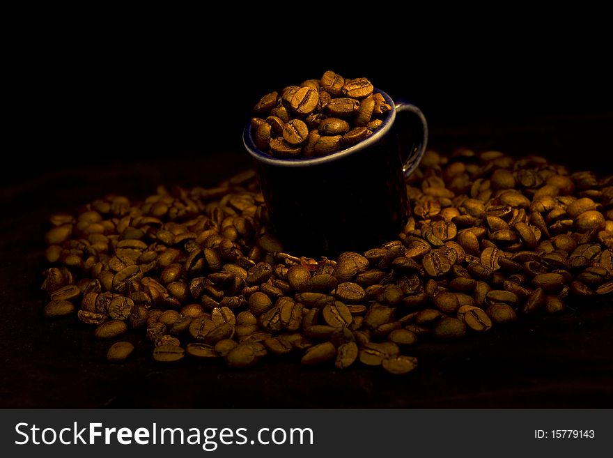 Dark Cup With Coffee Beans