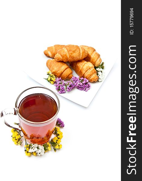 Tea and croissants with flowers design isolated on white