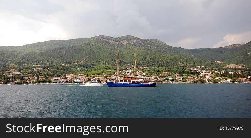 Panoramic view with summer mediterranean landscape, mountains , small town and ship in Boca Cotorska (Montenegro). Panoramic view with summer mediterranean landscape, mountains , small town and ship in Boca Cotorska (Montenegro)