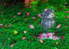 Red Maple Leaf On Head Of Jizo Sculpture Doll In Japanese Garden, Enkoji Temple, Kyoto, Japan Royalty Free Stock Photo