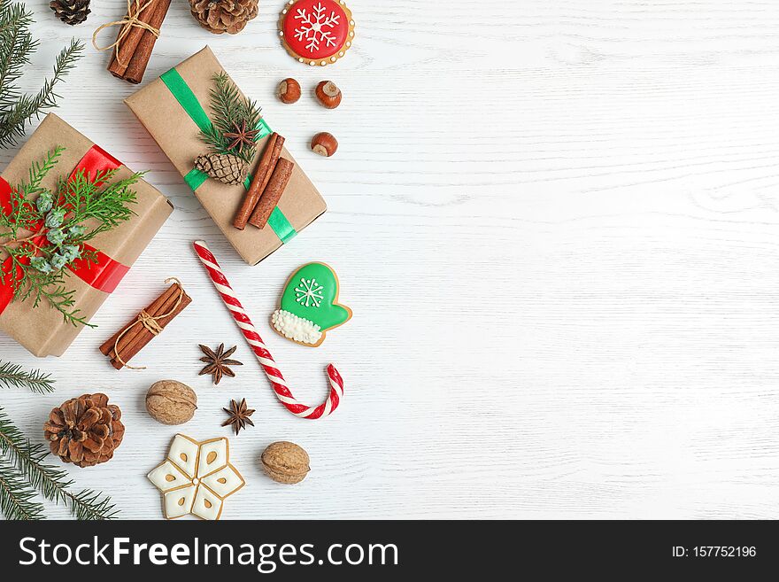 Flat lay composition with Christmas gift boxes on white wooden background