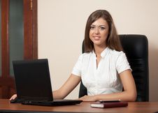 Young Woman Behind A Table With The Laptop Stock Photo