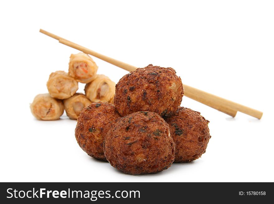 Meatballs and spring roll on white background