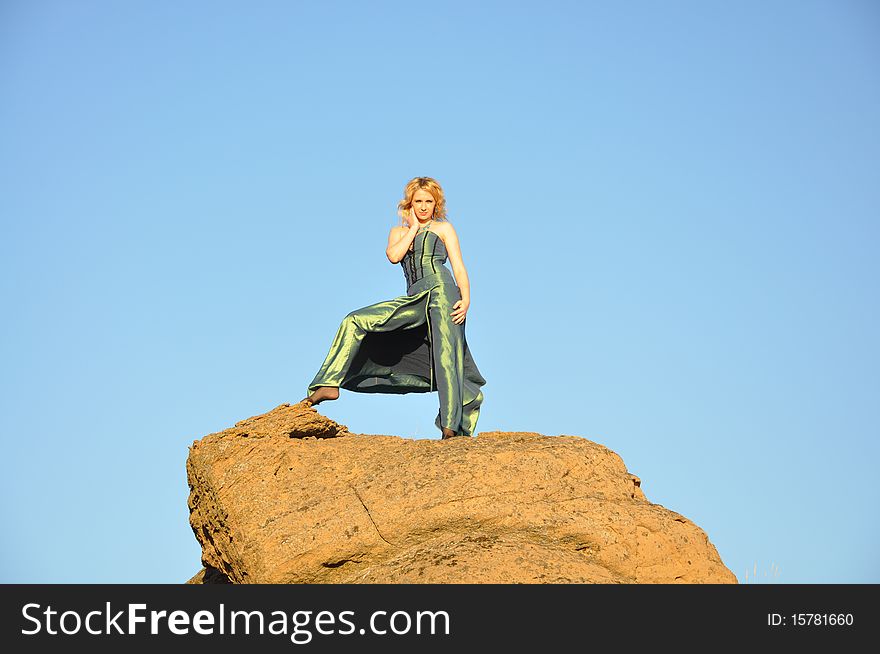 Attractive blond woman standing on the top of rock. Attractive blond woman standing on the top of rock