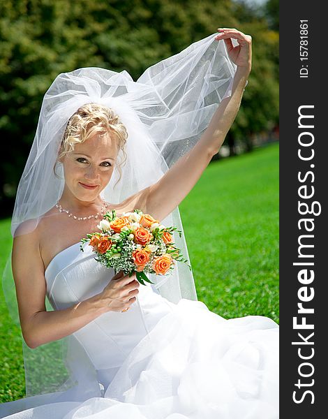 Young beautiful  bride with wedding bouquet. Young beautiful  bride with wedding bouquet