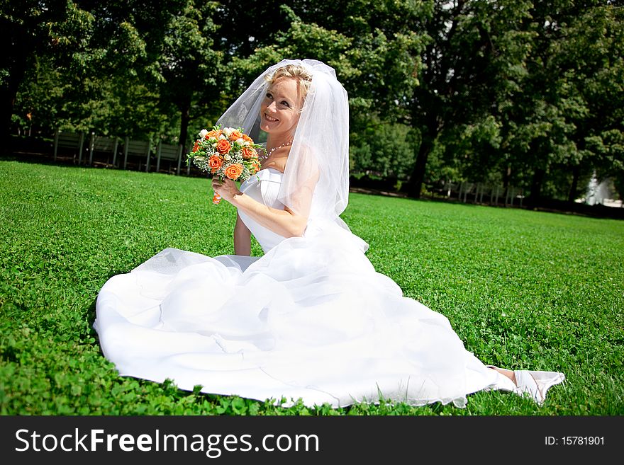 Young beautiful  bride with wedding bouquet. Young beautiful  bride with wedding bouquet