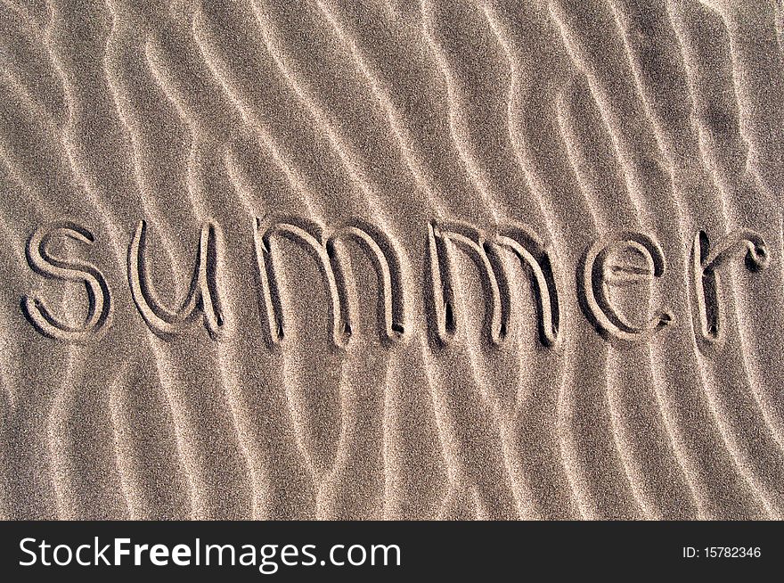 The word summer written in sand