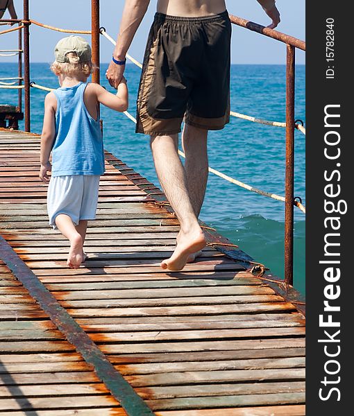 Father And Son Strolling On The Seacoast