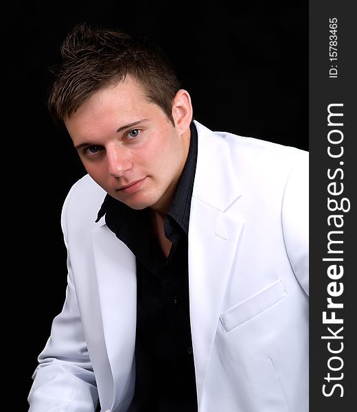 Portrait of young businessman over black background
