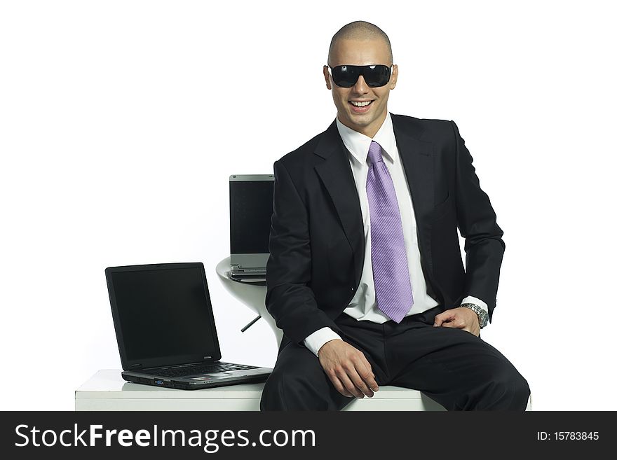 Smiling handsome businessman with two laptop computers. Smiling handsome businessman with two laptop computers