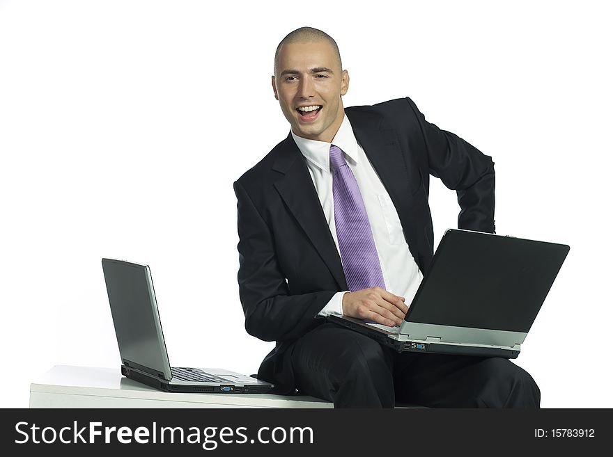 Handsome businessman with two laptop computers. Handsome businessman with two laptop computers