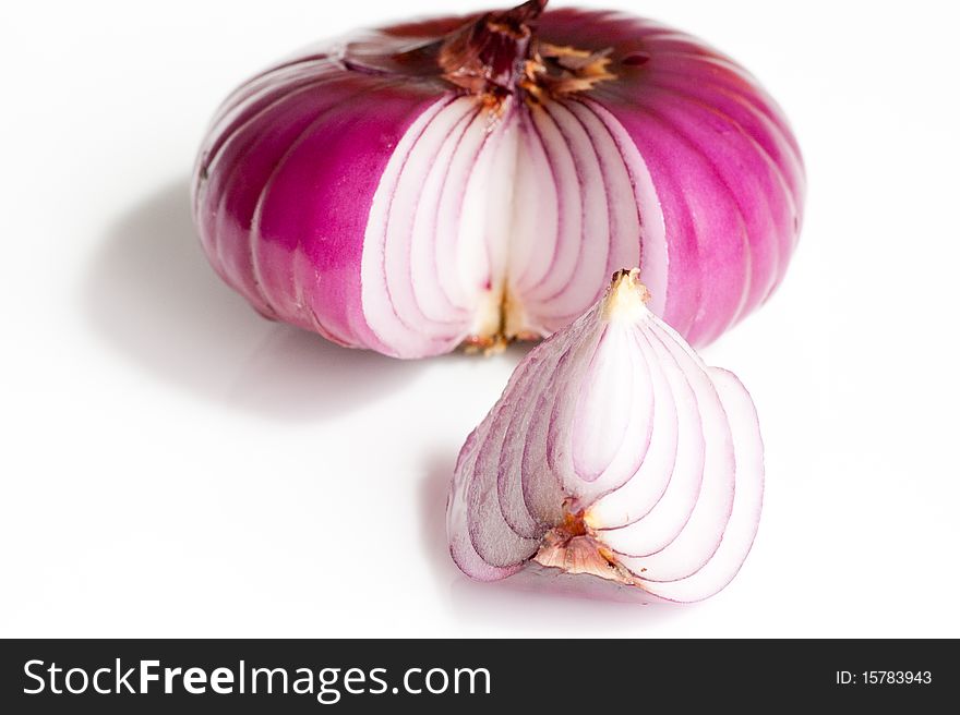 One and a piece red onion isolated on white