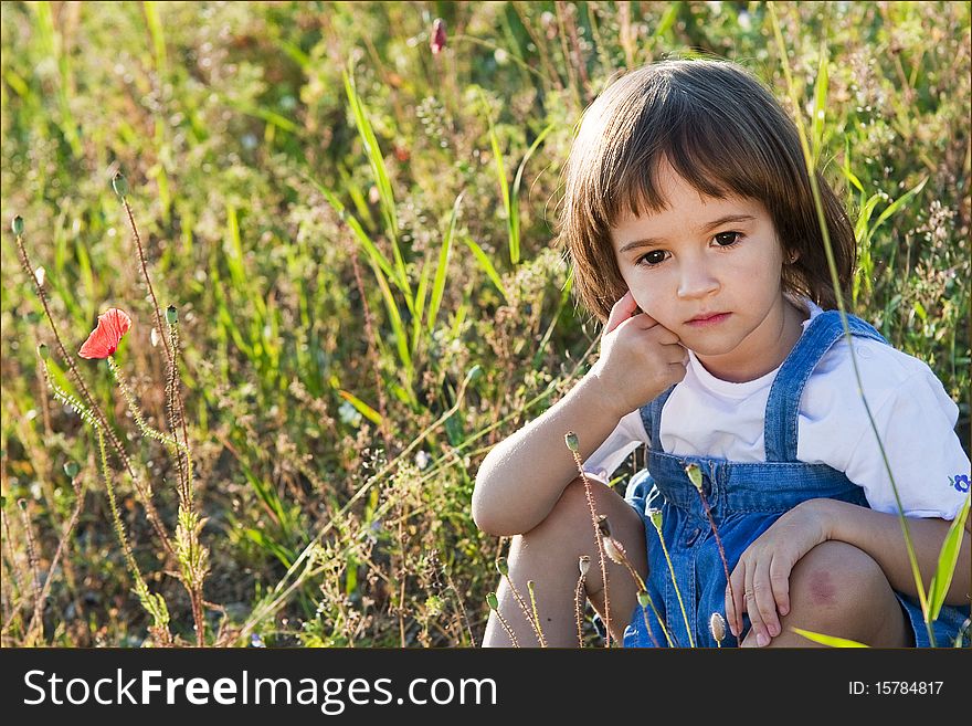 Portrait of a little girl in poppies field