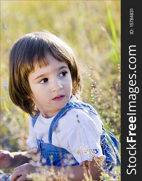 Portrait of a little girl in summer field. Portrait of a little girl in summer field