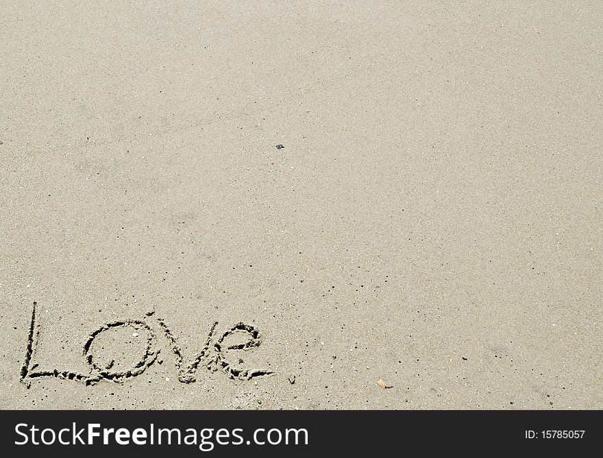 Love written in the sand - bottom left corner