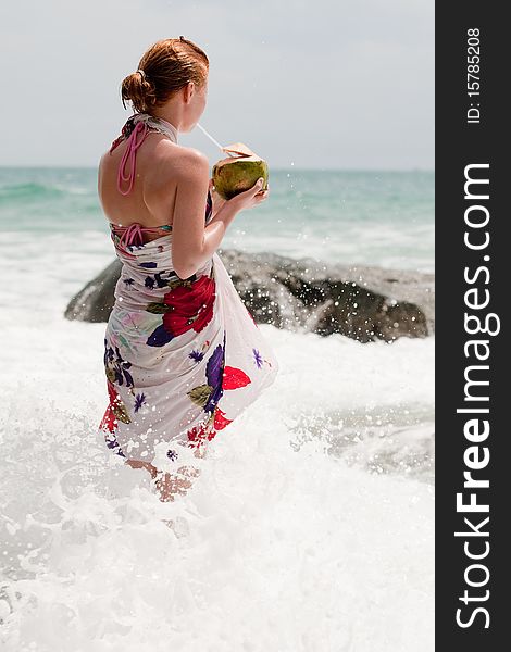 Vacation at the sea, teenager in bath clothing drink a coconut