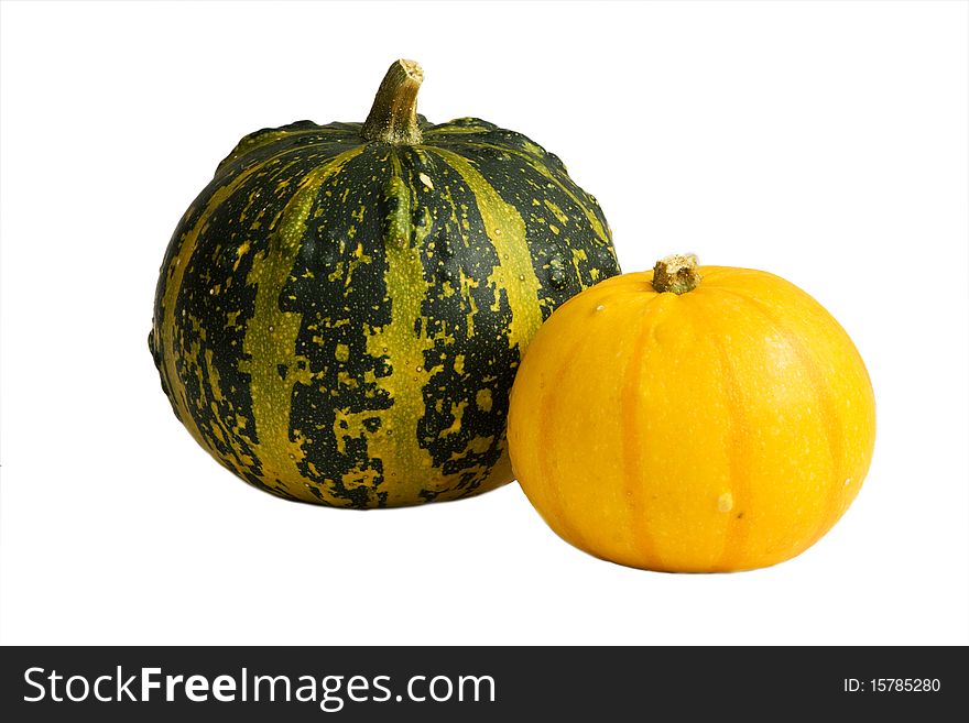 Two isolated gourds - yellow and green. Two isolated gourds - yellow and green