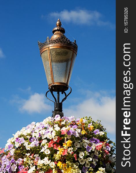 A light-post decorated with flowers. A light-post decorated with flowers