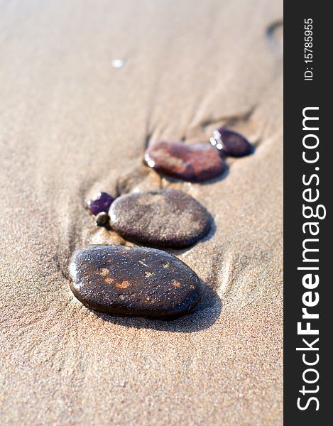 Stones on the seashore with reflections on water. Stones on the seashore with reflections on water
