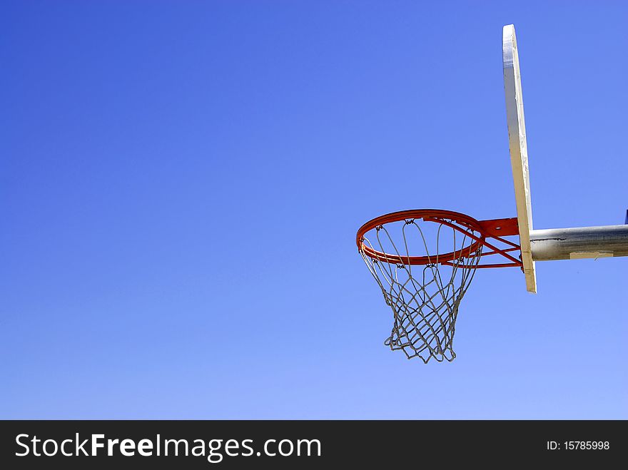 Basketball hoop with blue sky in the background