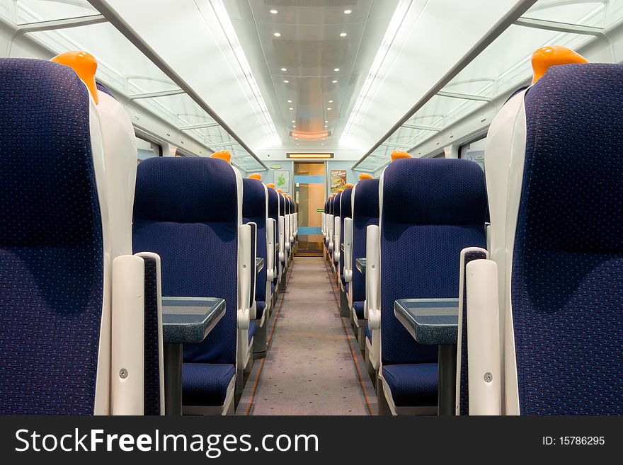 Modern railway coach interior illuminated and  row of seats