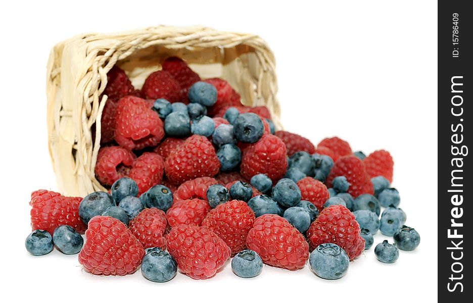 Fresh, juicy raspberries, blueberries and wicker basket, isolated on white background. Fresh, juicy raspberries, blueberries and wicker basket, isolated on white background.
