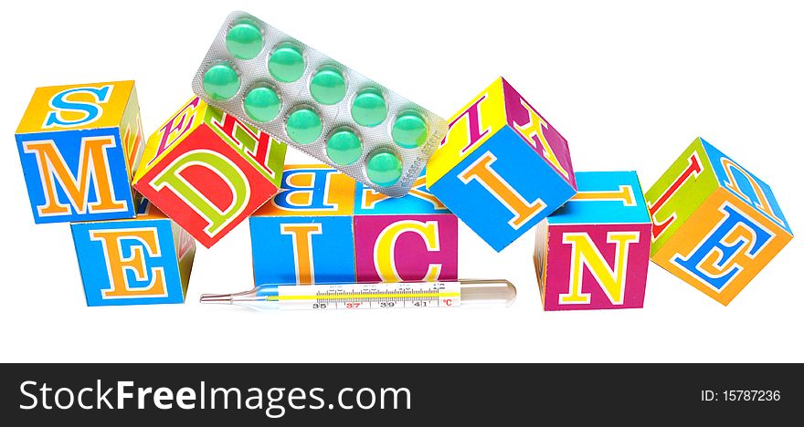 Thermometer in front of some cubes with the word medicine. Thermometer in front of some cubes with the word medicine